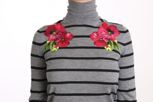Grey sweater with black stripes and red flowers on shoulders