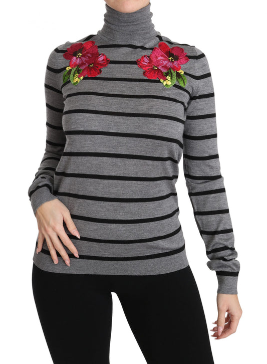 Black and white striped sweater with red flower embellishments on shoulders