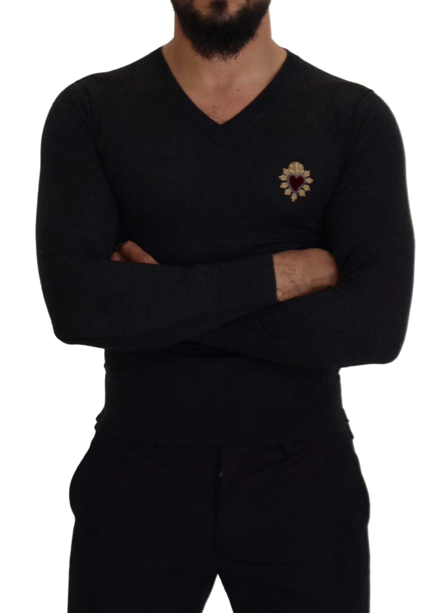 Man wearing black shirt with gold emblem