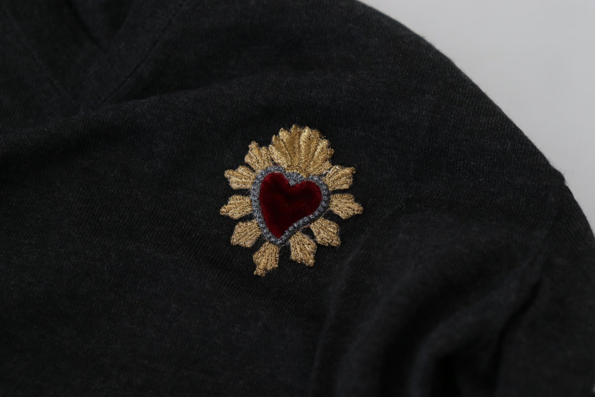 Black sweater with gold heart embroidery on sleeve