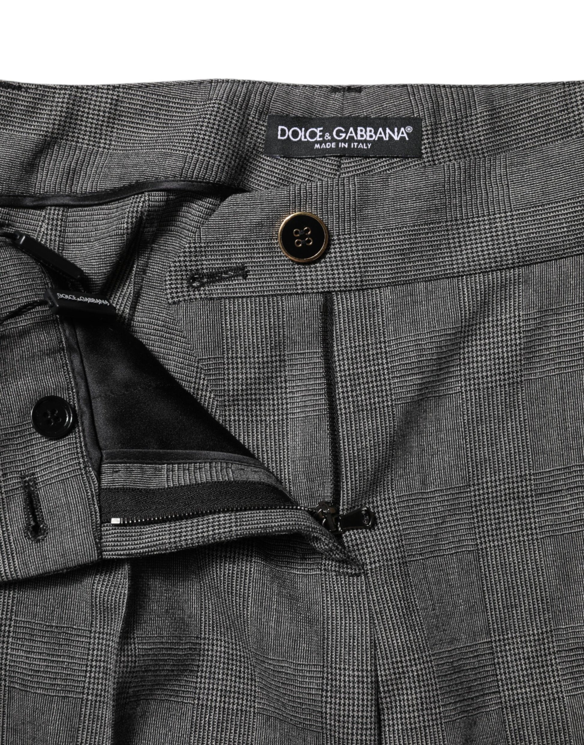 Pair of gray trousers with black buttons and label