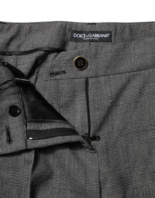 Pair of gray trousers with black buttons and label