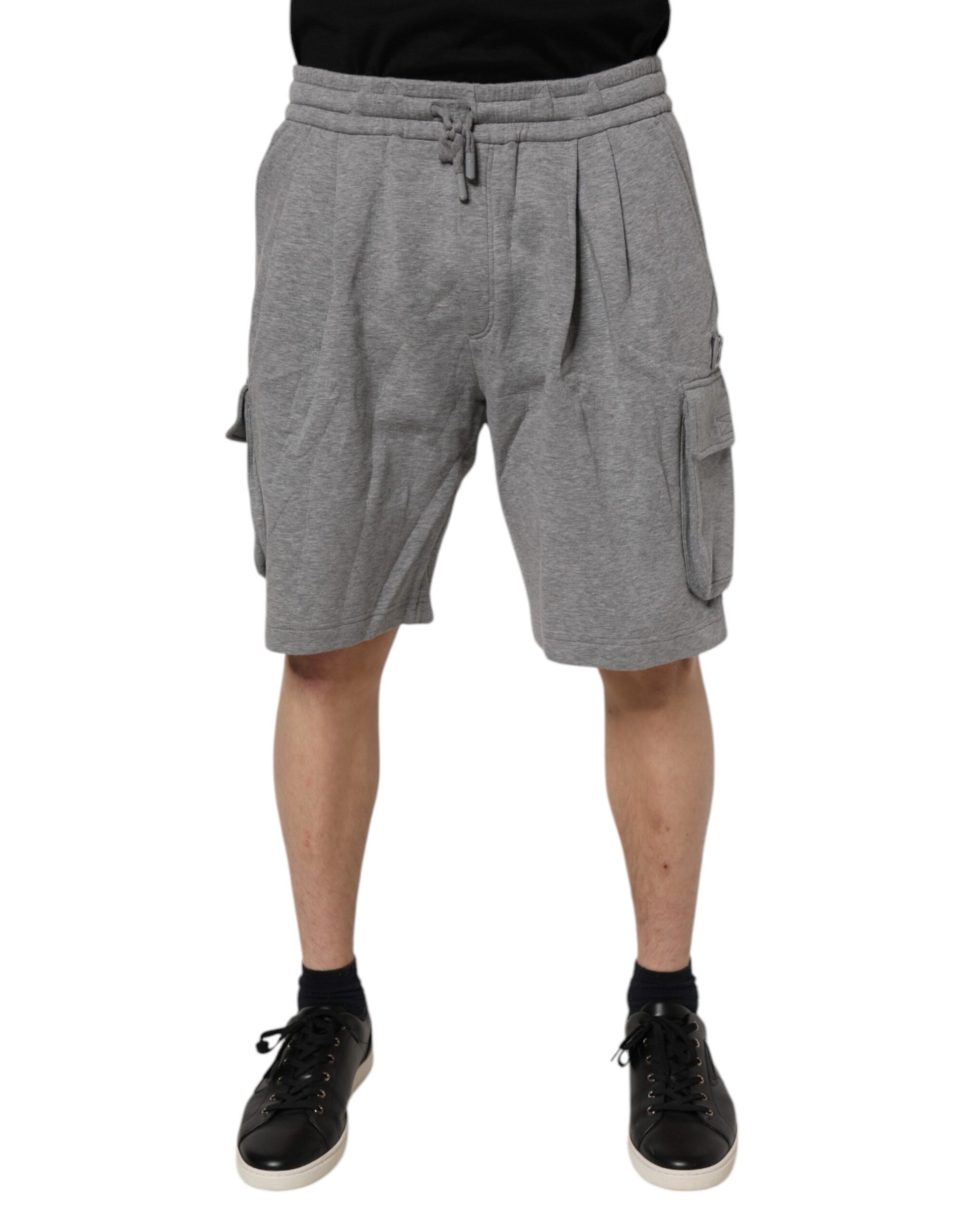 A pair of gray cotton cargo shorts with pockets on the sides. They are designed by Dolce & Gabbana and appear