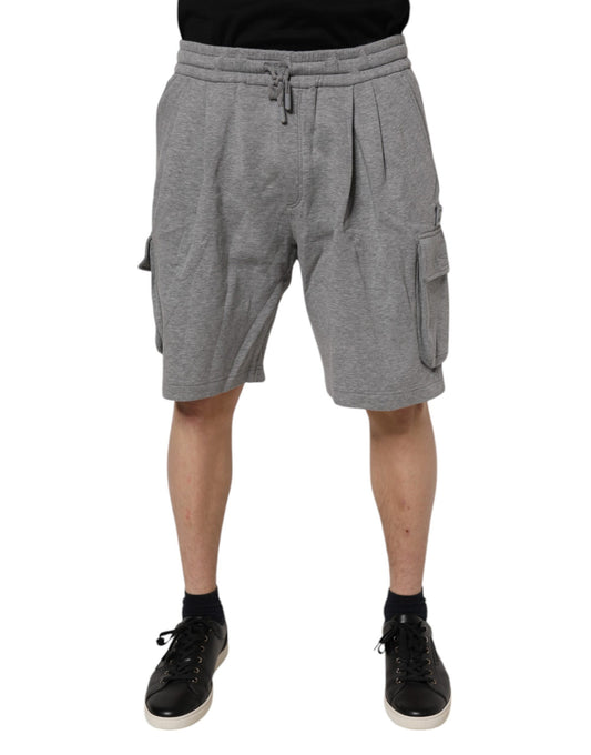 A pair of gray cotton cargo shorts with pockets on the sides. They are designed by Dolce & Gabbana and appear