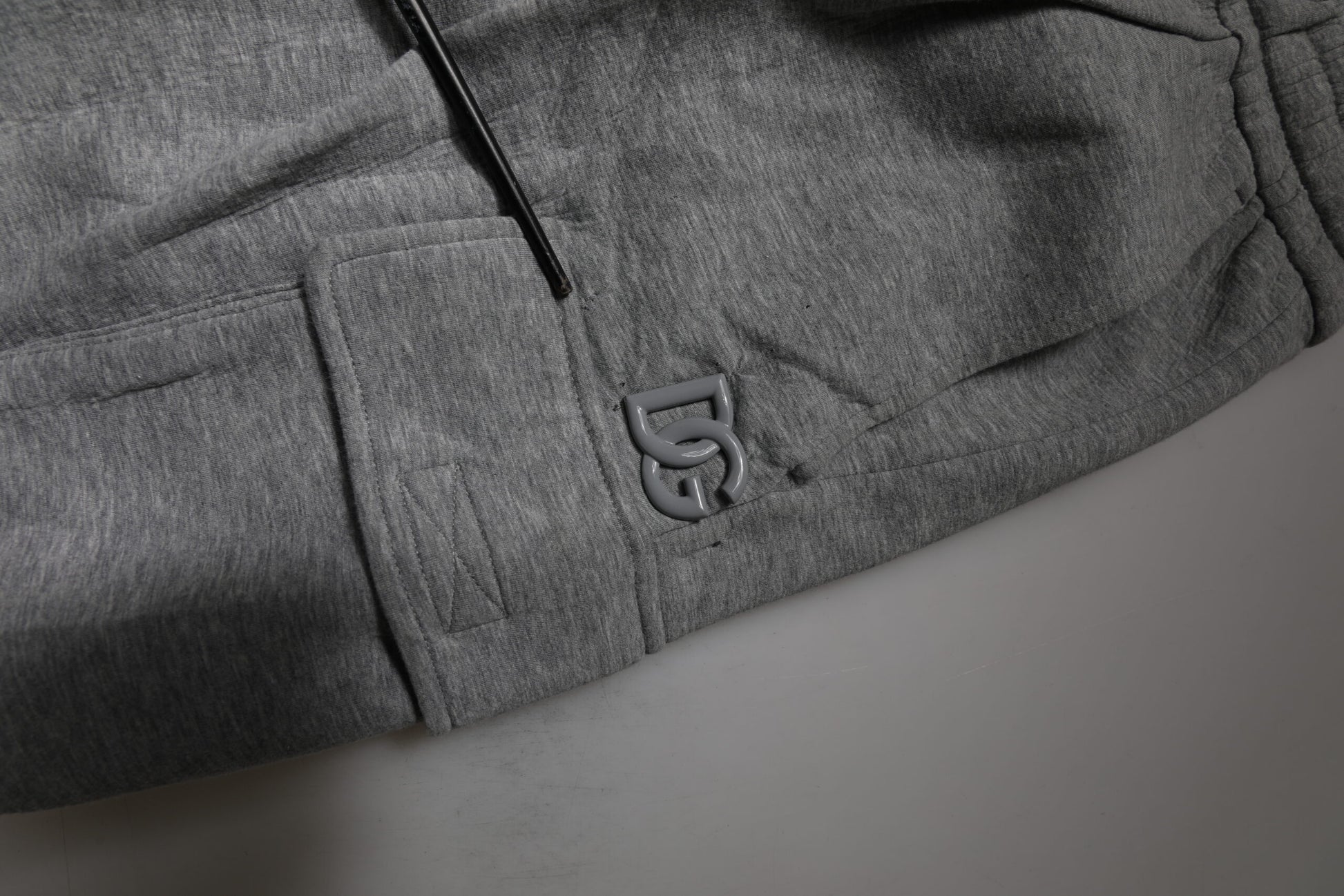 A pair of gray cotton cargo bermuda sweatshorts with the brand logo embroidered on the left leg