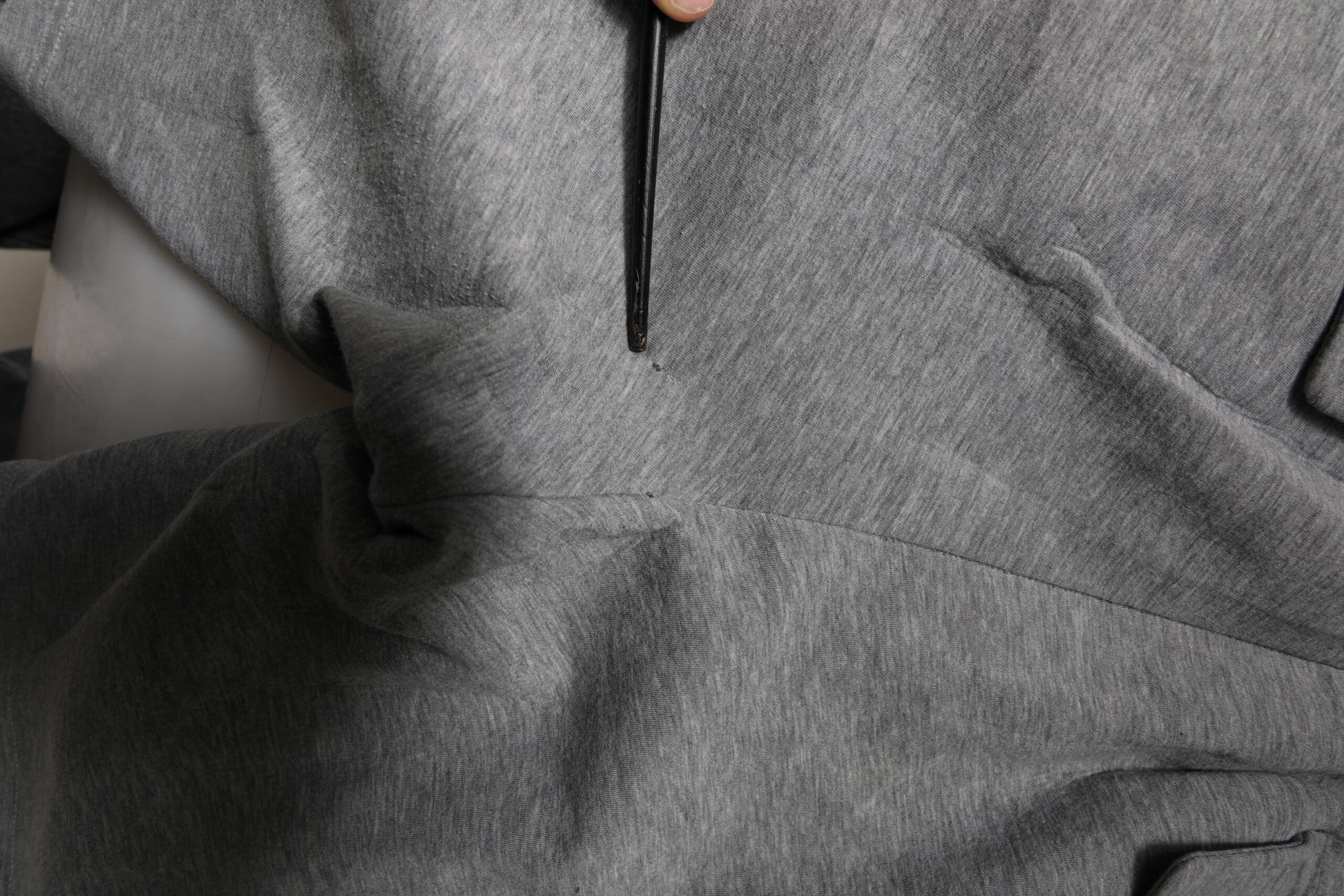 A gray cotton cargo sweat shorts with a zippered front pocket