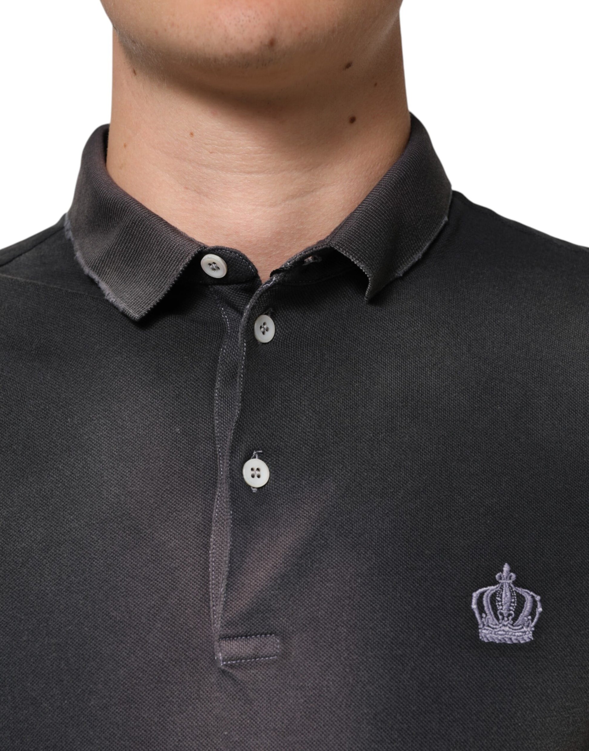 The shirt is black with a logo on the left chest area