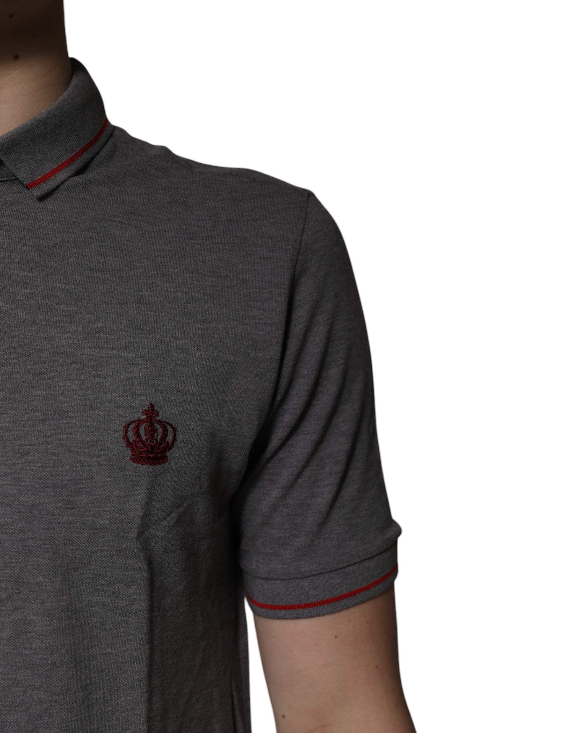 A gray polo shirt with a collar and a crown logo on the left chest