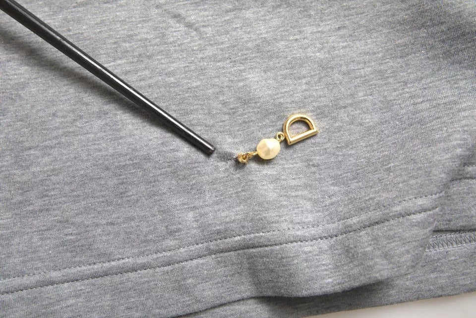 Gold key ring on black string