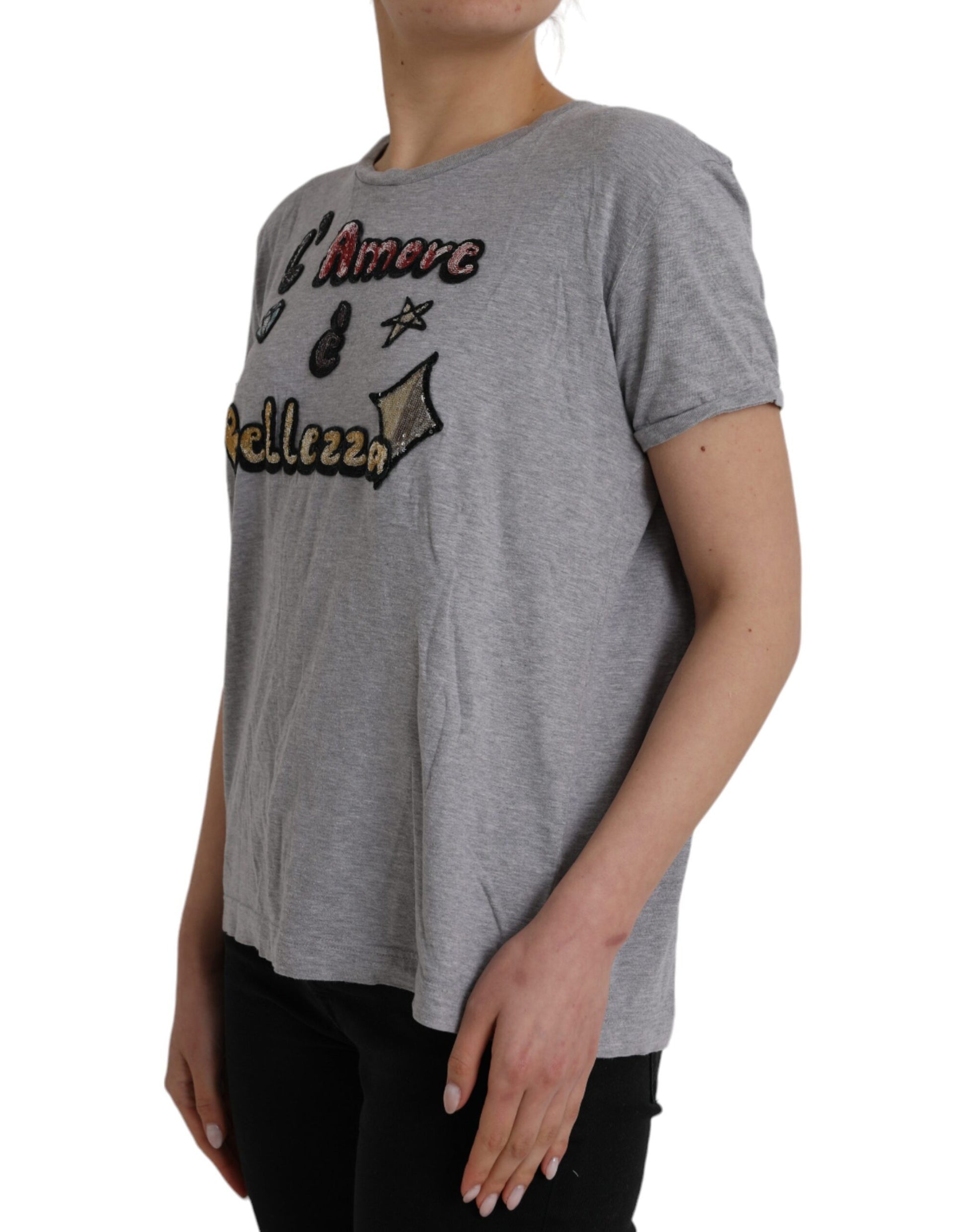 Woman wearing gray shirt with red lettering