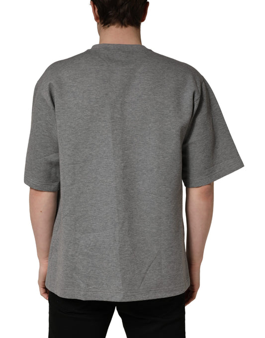 The back of a gray cotton crew neck t-shirt with logo applique