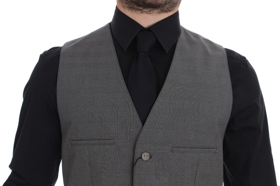 A gray cotton vest with a button front, slim fit, and part of a suit