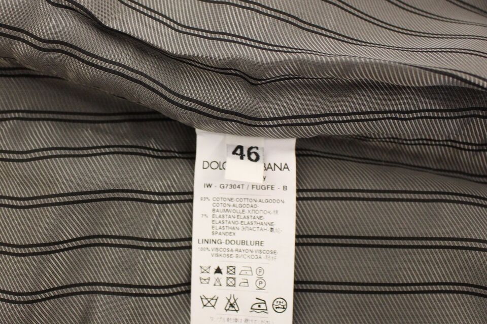 A gray cotton stretch dress vest blazer with a label indicating it is from the brand Dolce & Gabbana