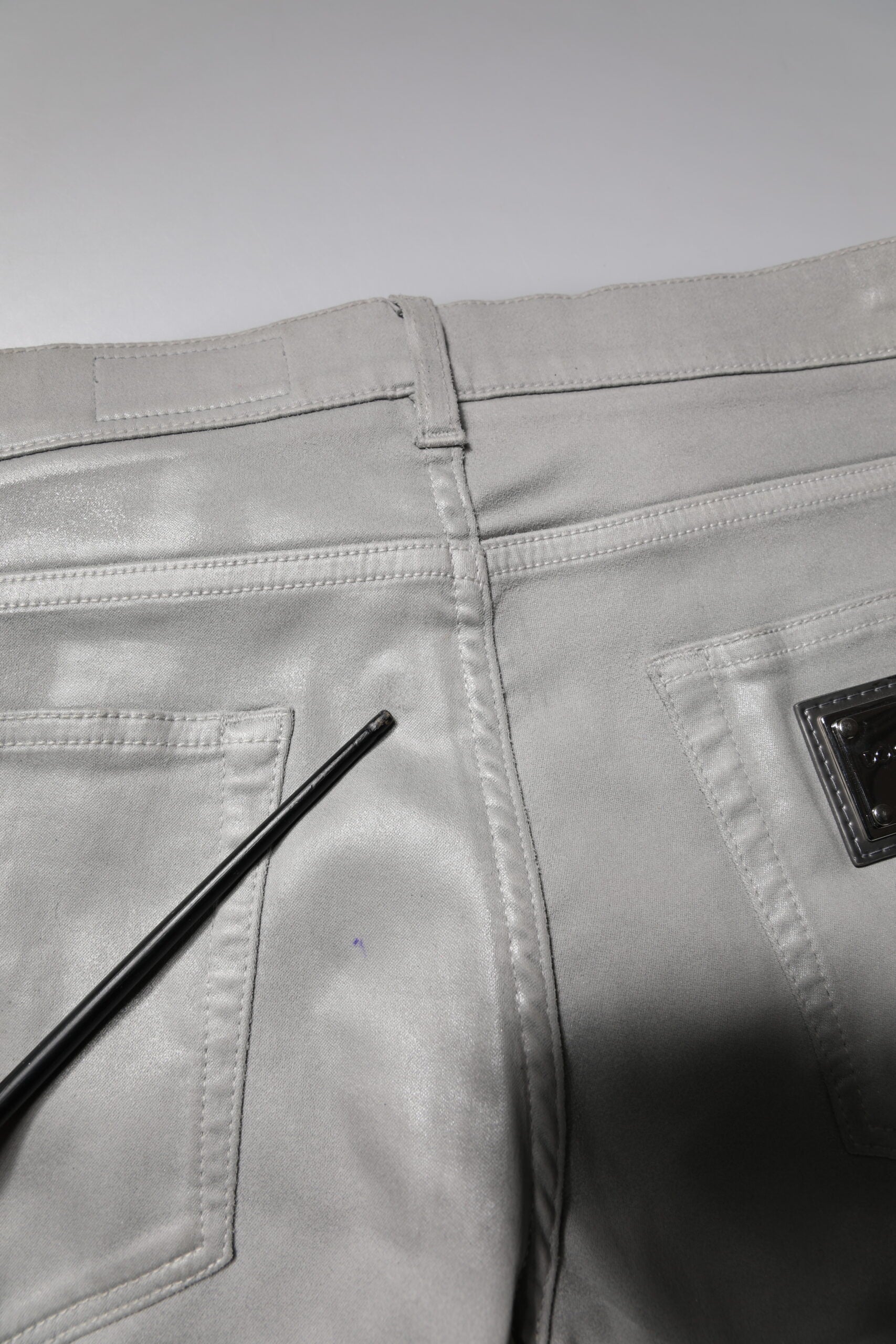 Pair of light grey jeans with black zipper