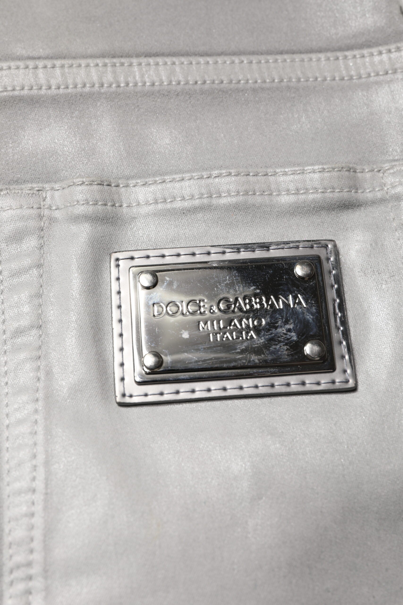 Silver metal logo on fabric