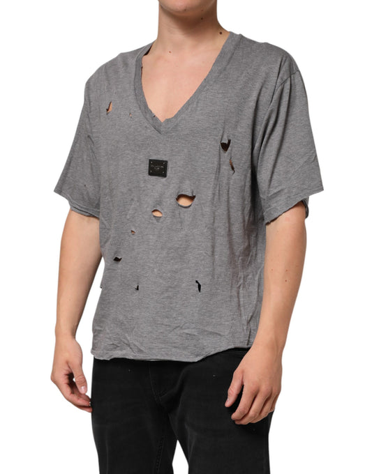Man wearing gray shirt with holes in front