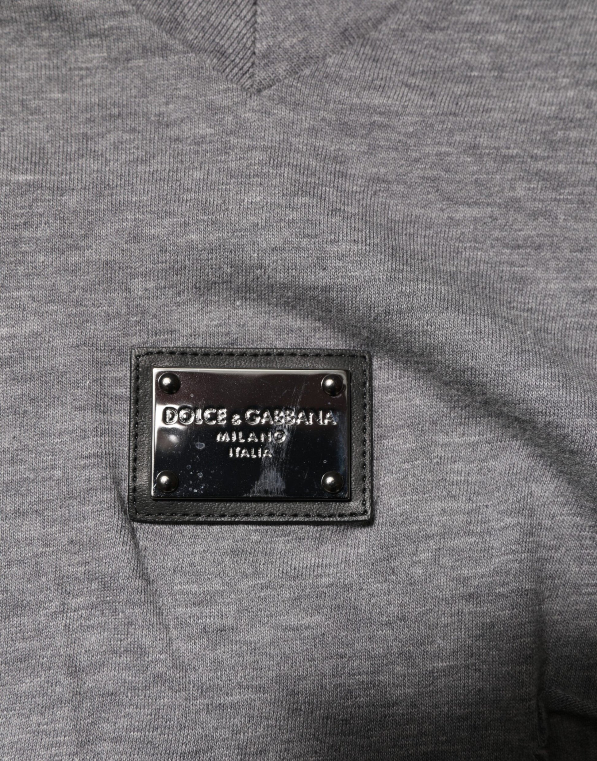 Grey sweater with black label on front