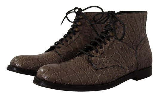 Pair of brown boots with laces and a crocodile skin texture design