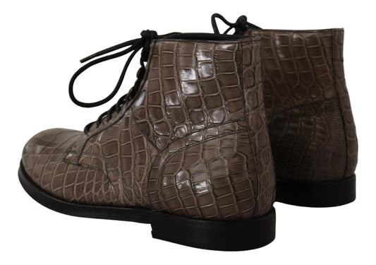 Pair of brown leather boots with laces and a buckle on top