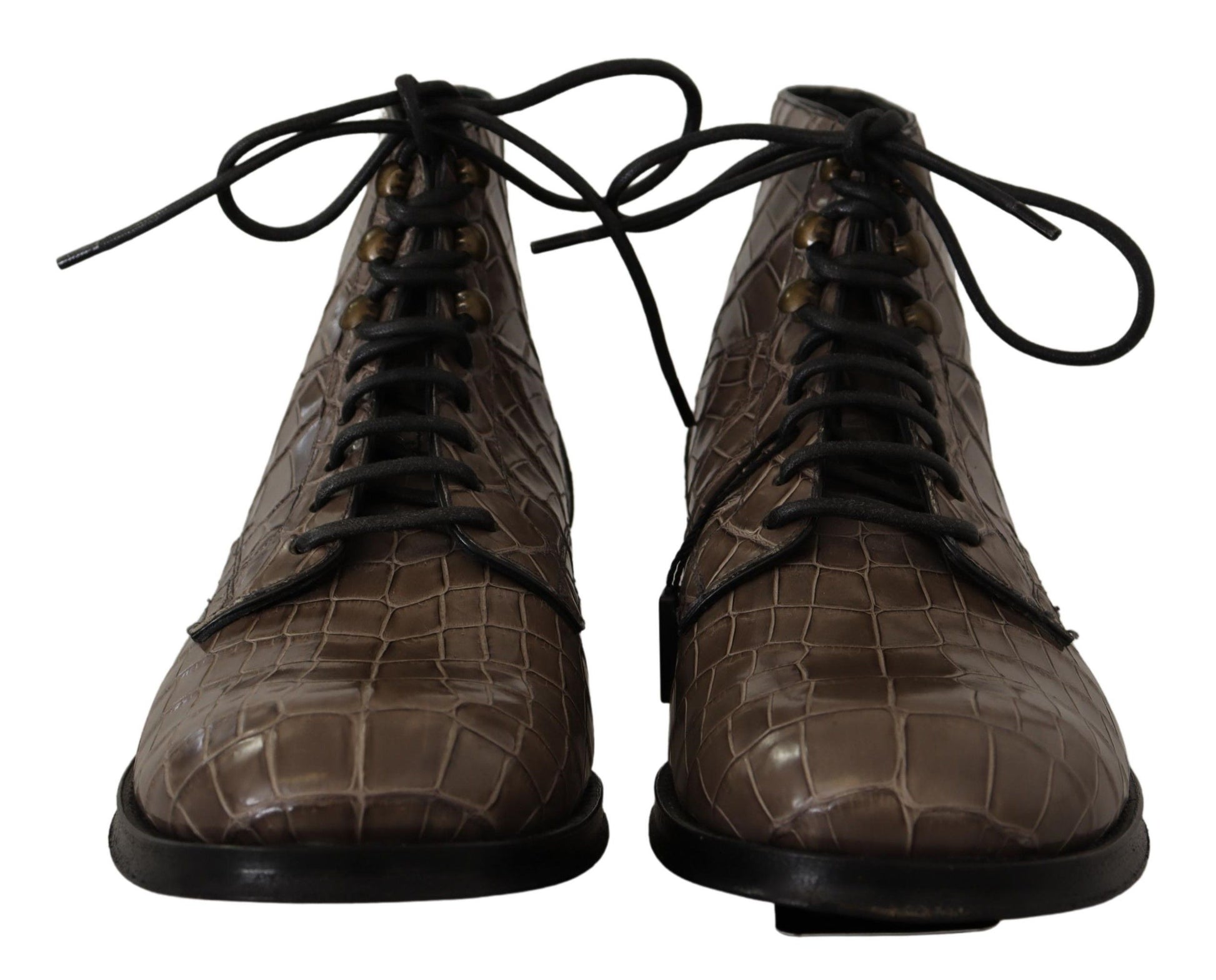Pair of brown leather boots with laces tied around them