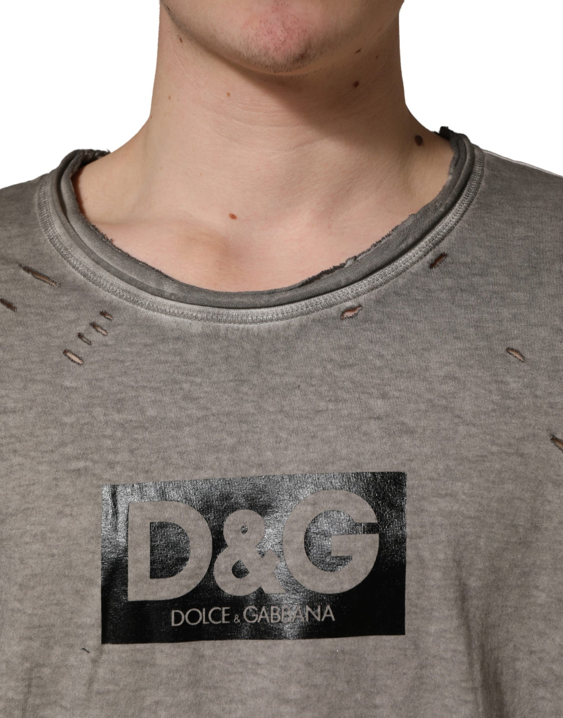 Man wearing gray shirt with black logo