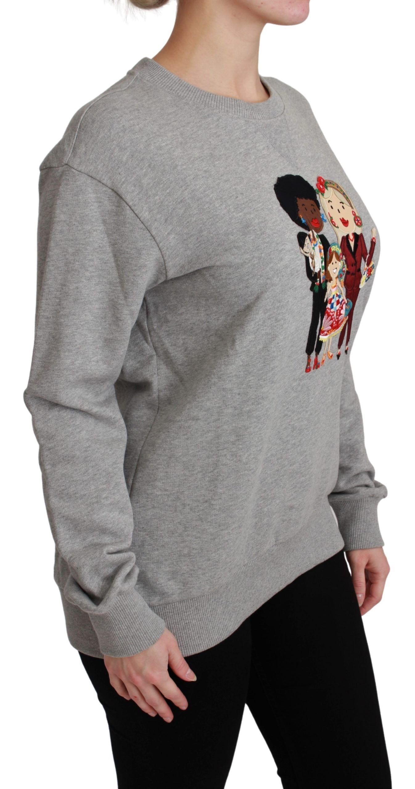 Woman wearing gray sweatshirt with graphic design on front