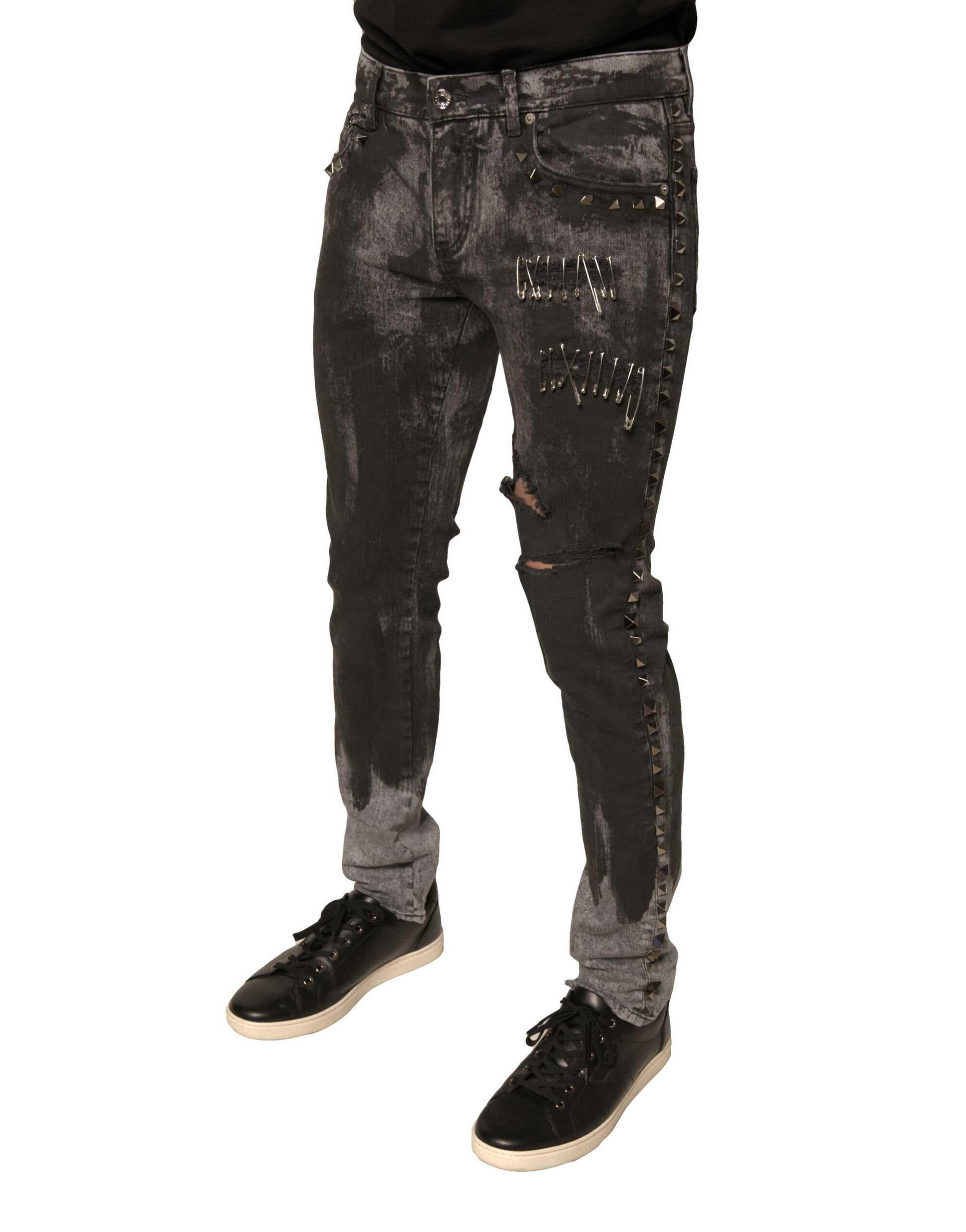Pair of distressed jeans with rips and studs