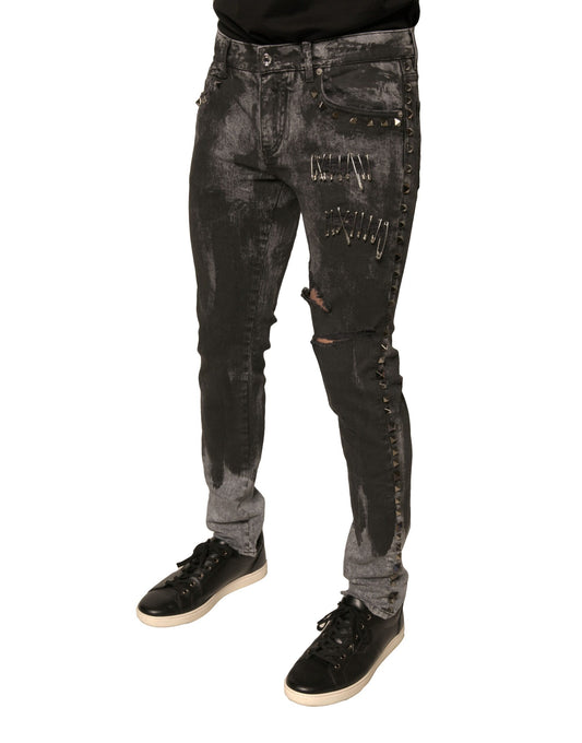 Pair of distressed jeans with rips and studs
