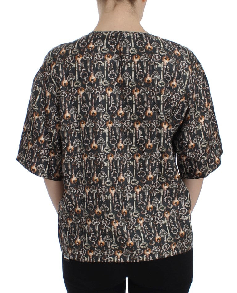 The back of a woman's shirt with a pattern of people playing instruments