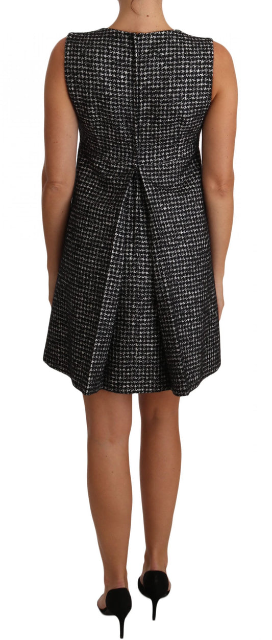 A black and white dress with floral applique on the front