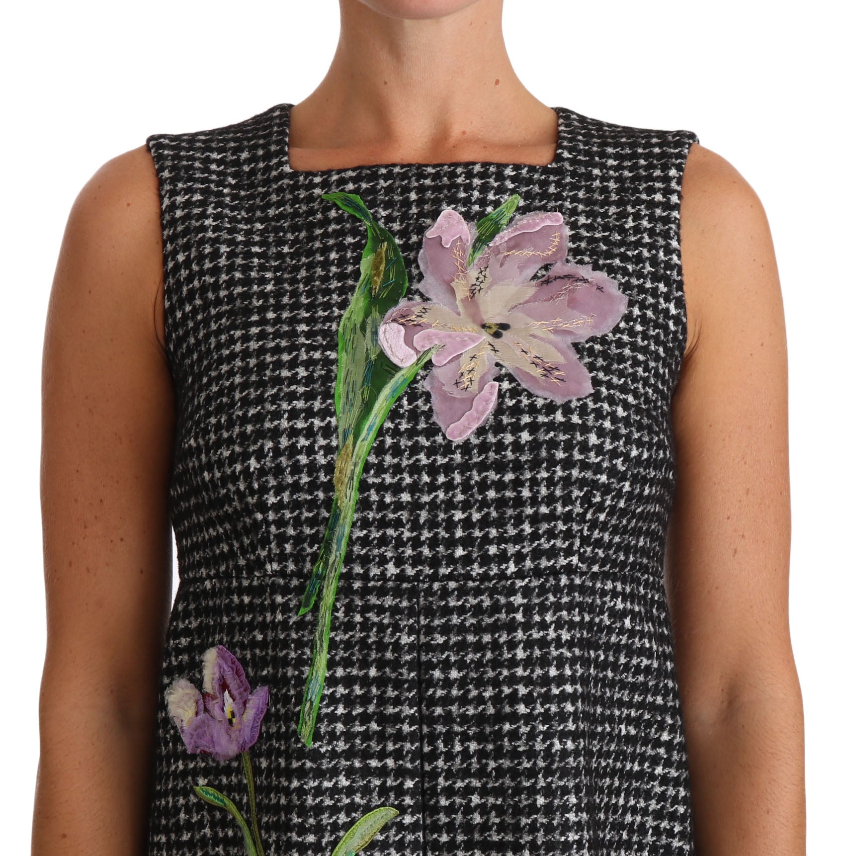 A gray houndstooth dress with a floral applique on the front