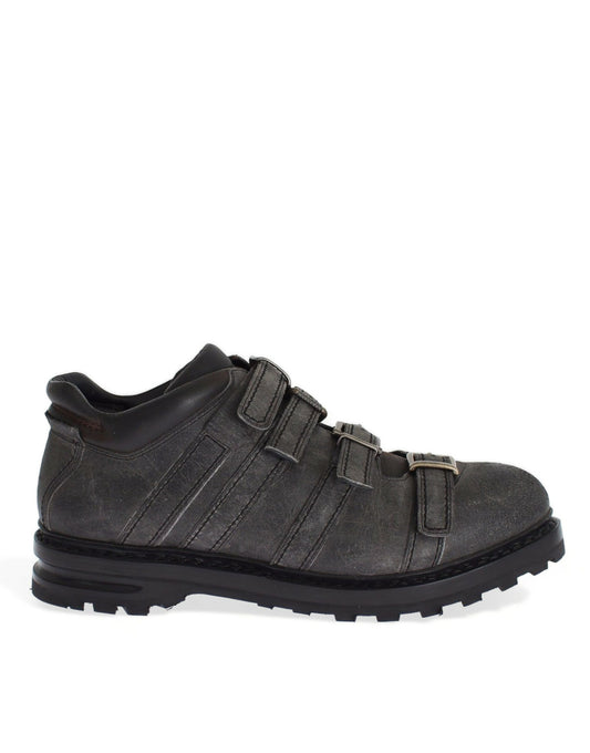 Black leather hiking boot with laces and a strap across the top