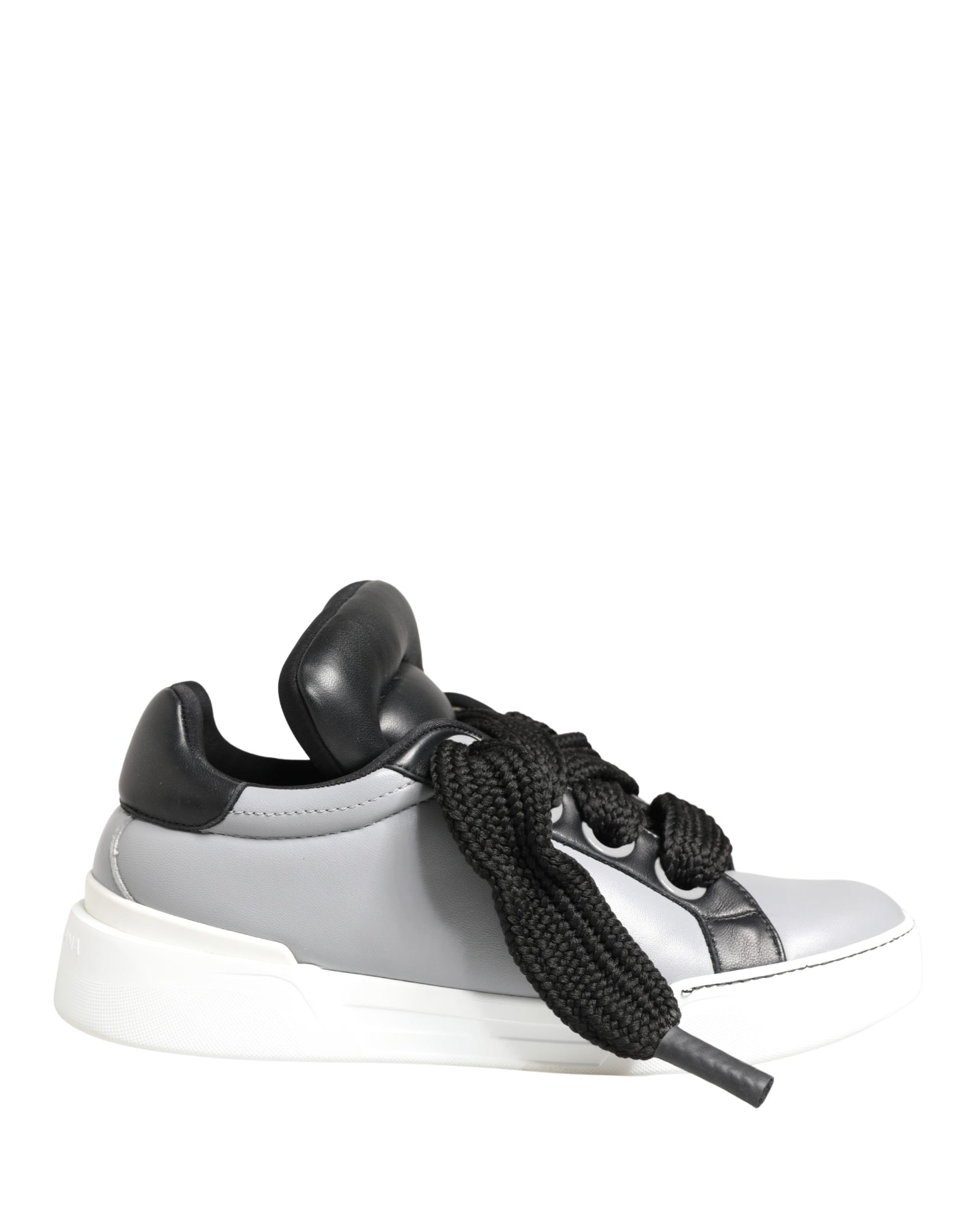 A pair of gray leather low top lace up sneakers with black accents