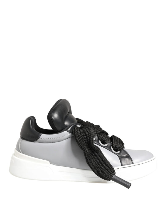 A pair of gray leather low top lace up sneakers with black accents