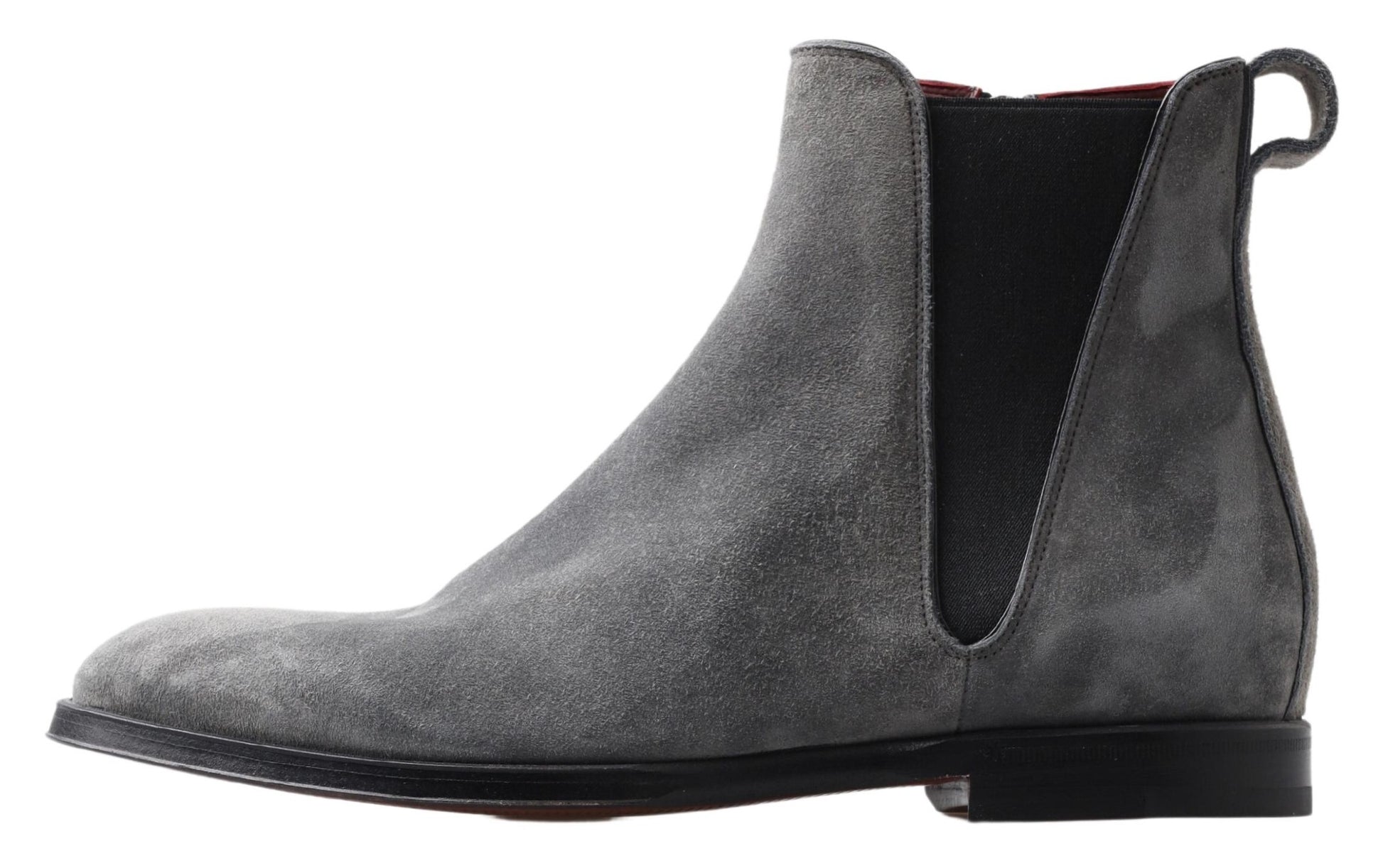 A single gray suede boot with a black zipper and a red pull tab. It has a round toe and is standing upright against a neu