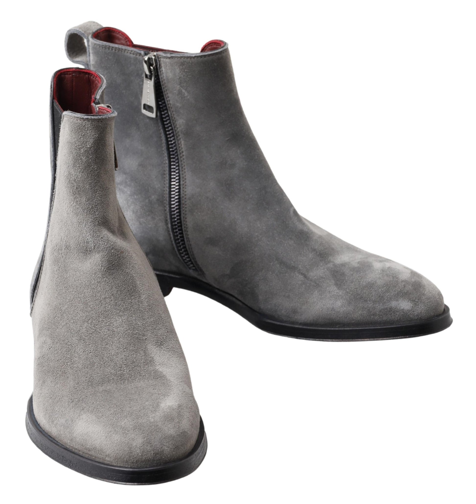 Pair of grey suede boots with zipper on side and black soles