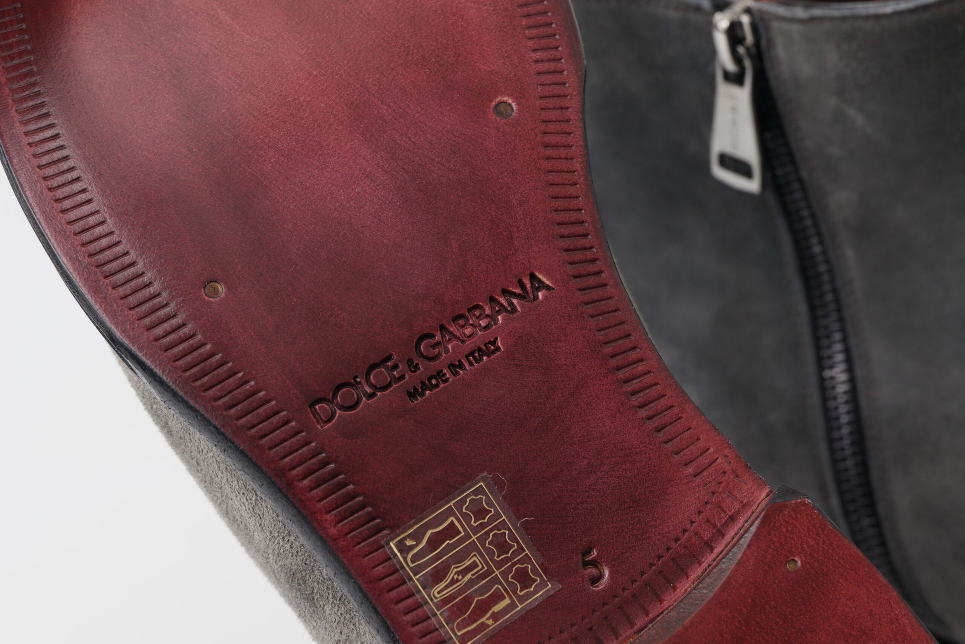 Red and black leather boot with visible stitching and brand label