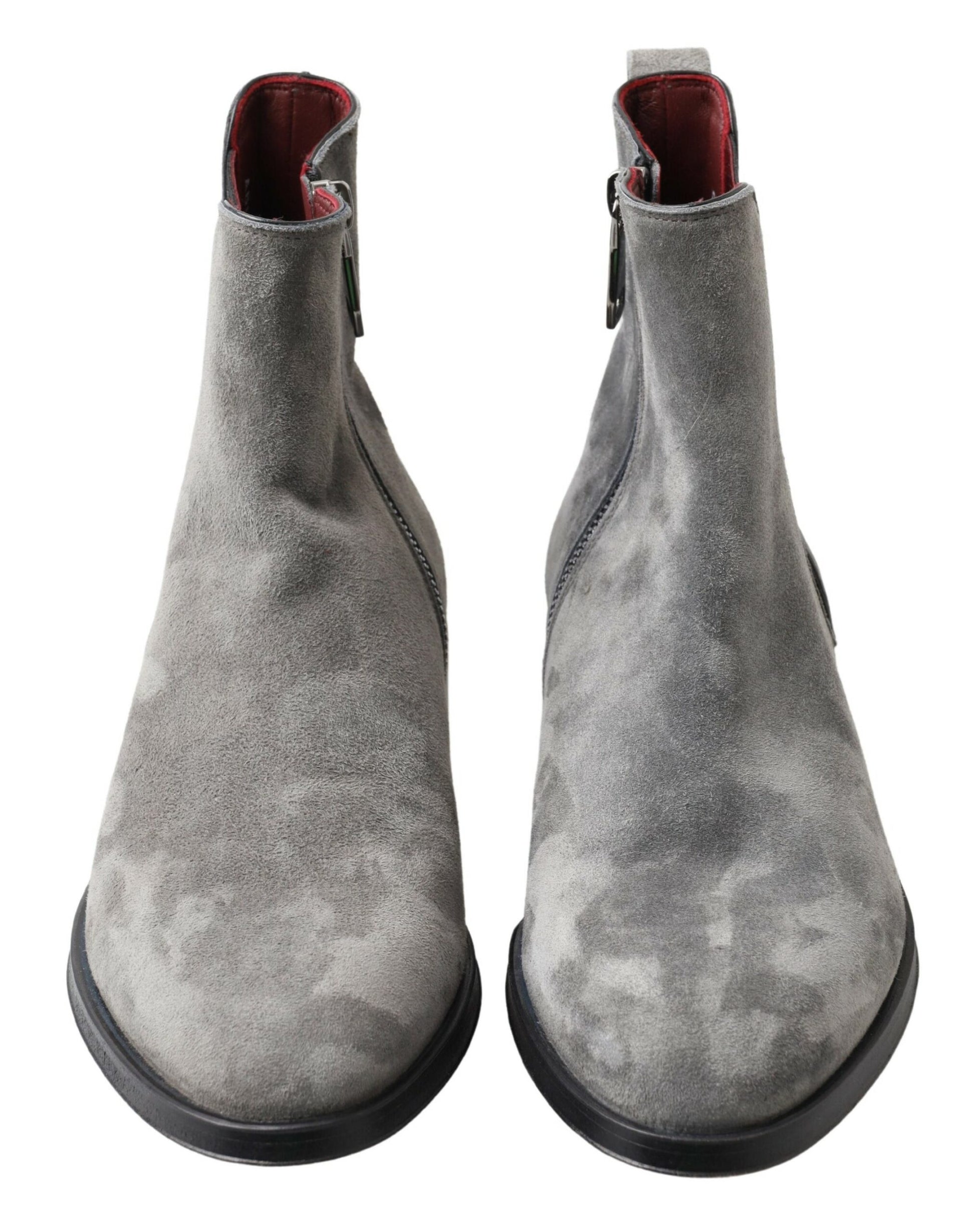 Pair of gray suede boots with black soles and laces