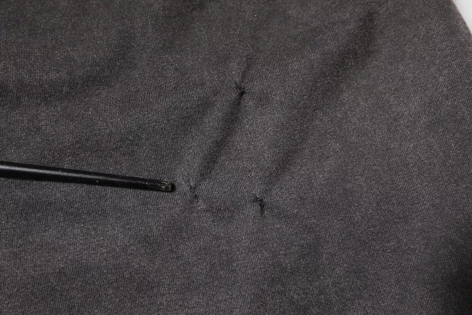 Black metal object in fabric