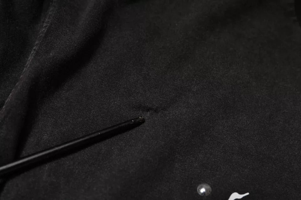Black fabric with a small hole in it