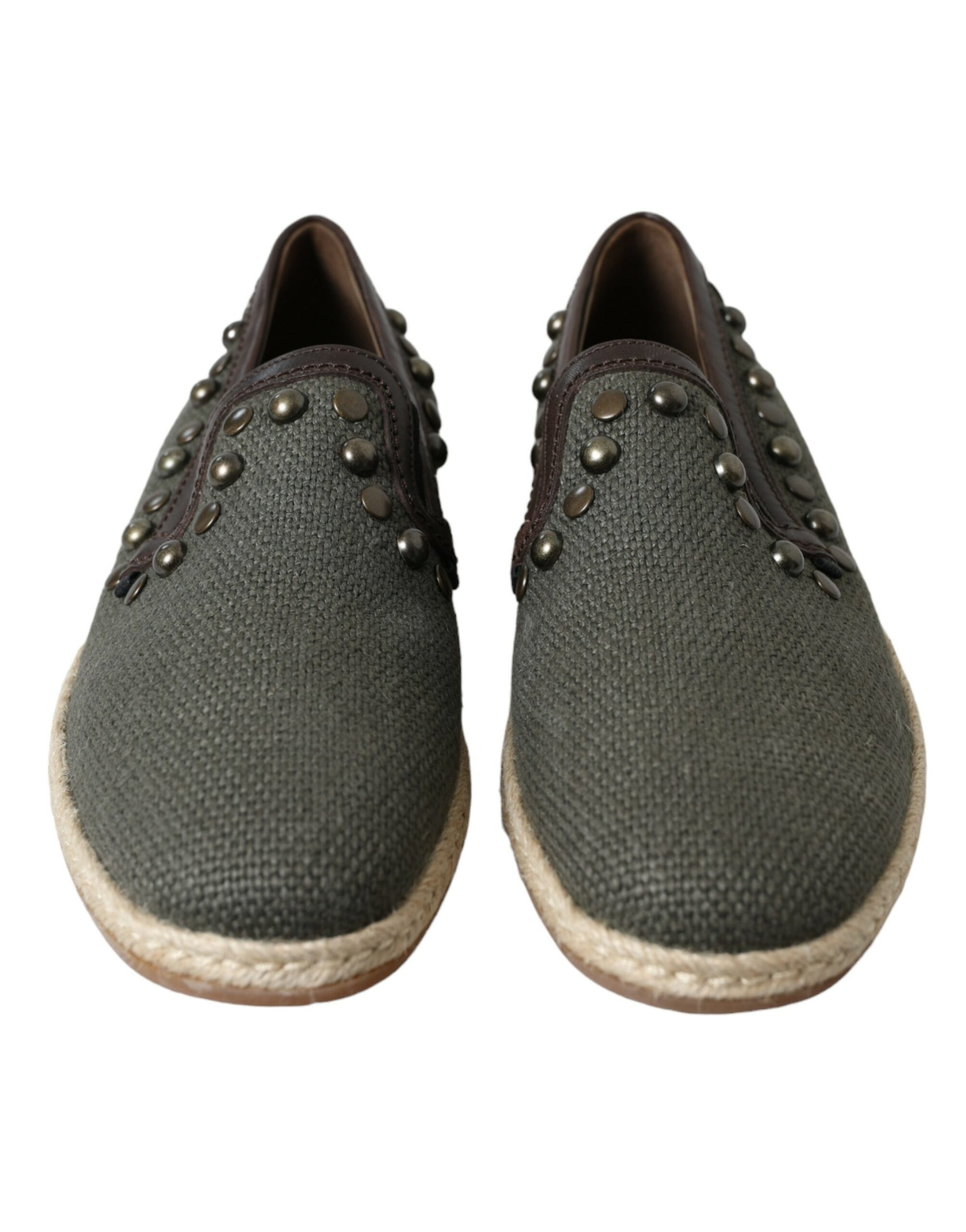 Pair of gray shoes with brown soles and silver studs on straps