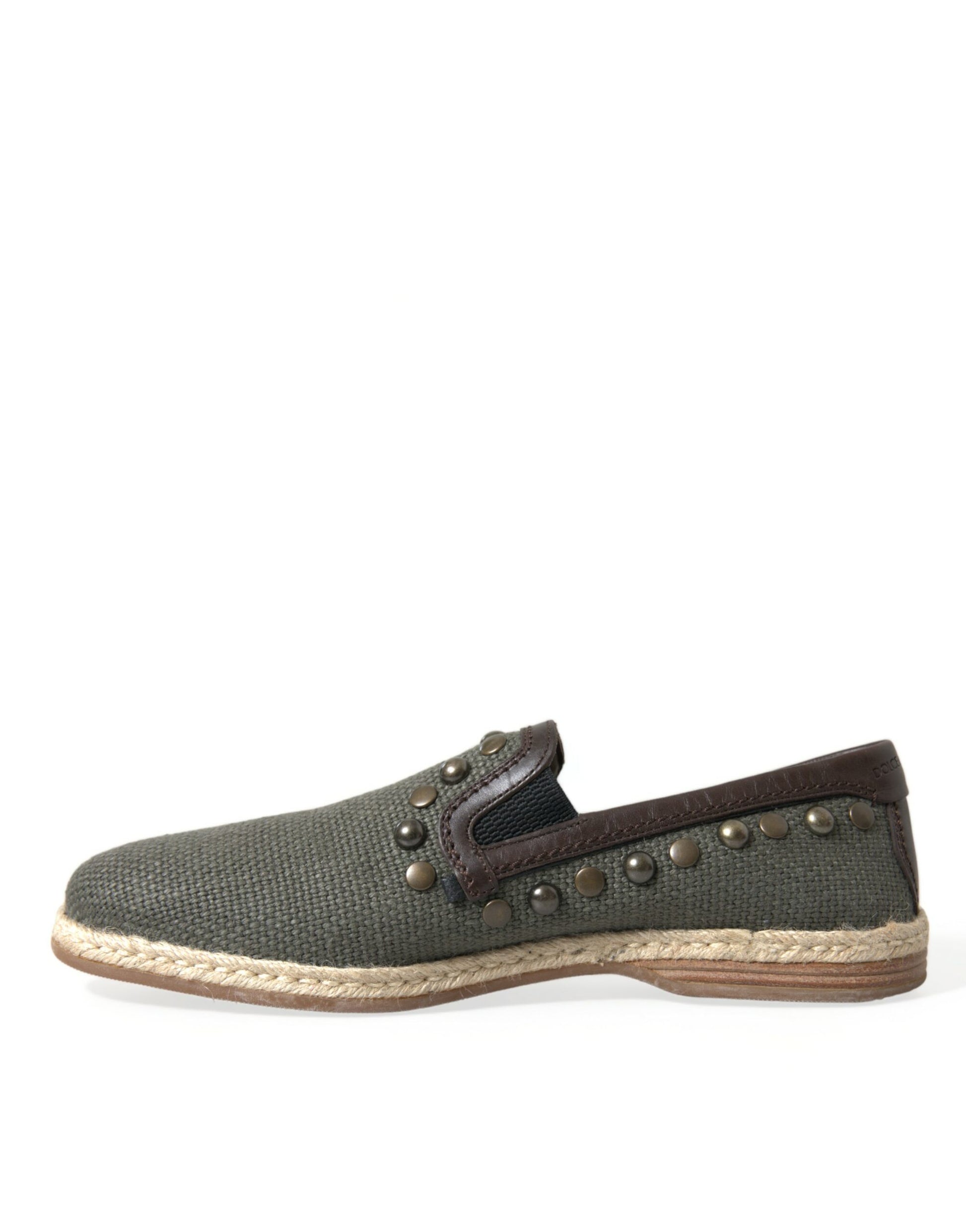 A single shoe against a white background. It appears to be a children's shoe with a dark green upper and a light brown so
