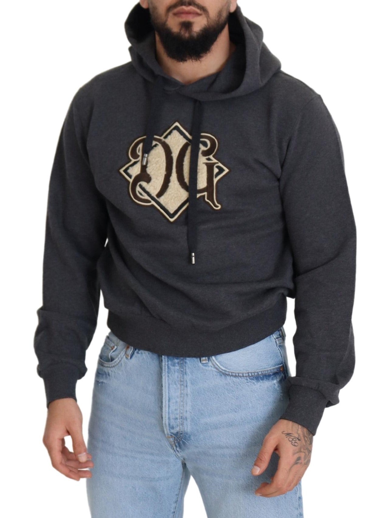 Man wearing gray hoodie with emblem on front