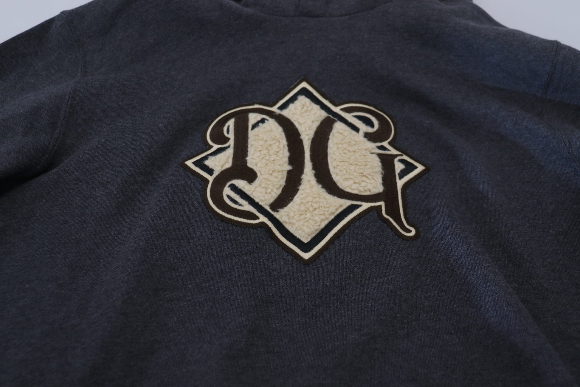 Black sweater with embroidered initials on front