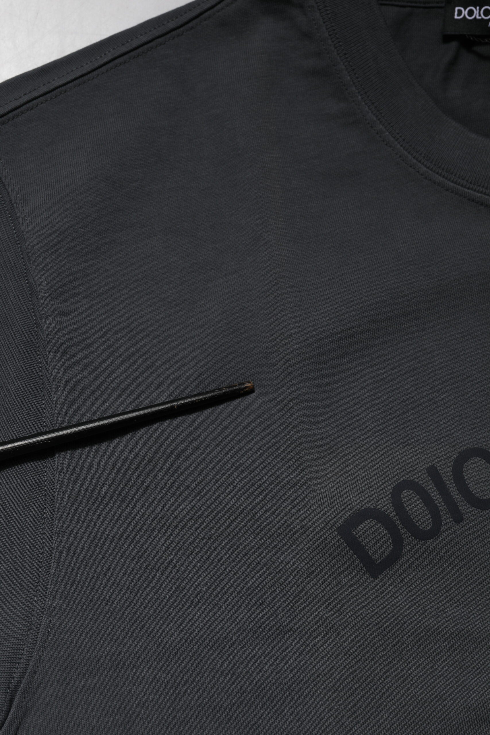 Black athletic shirt with white logo on front