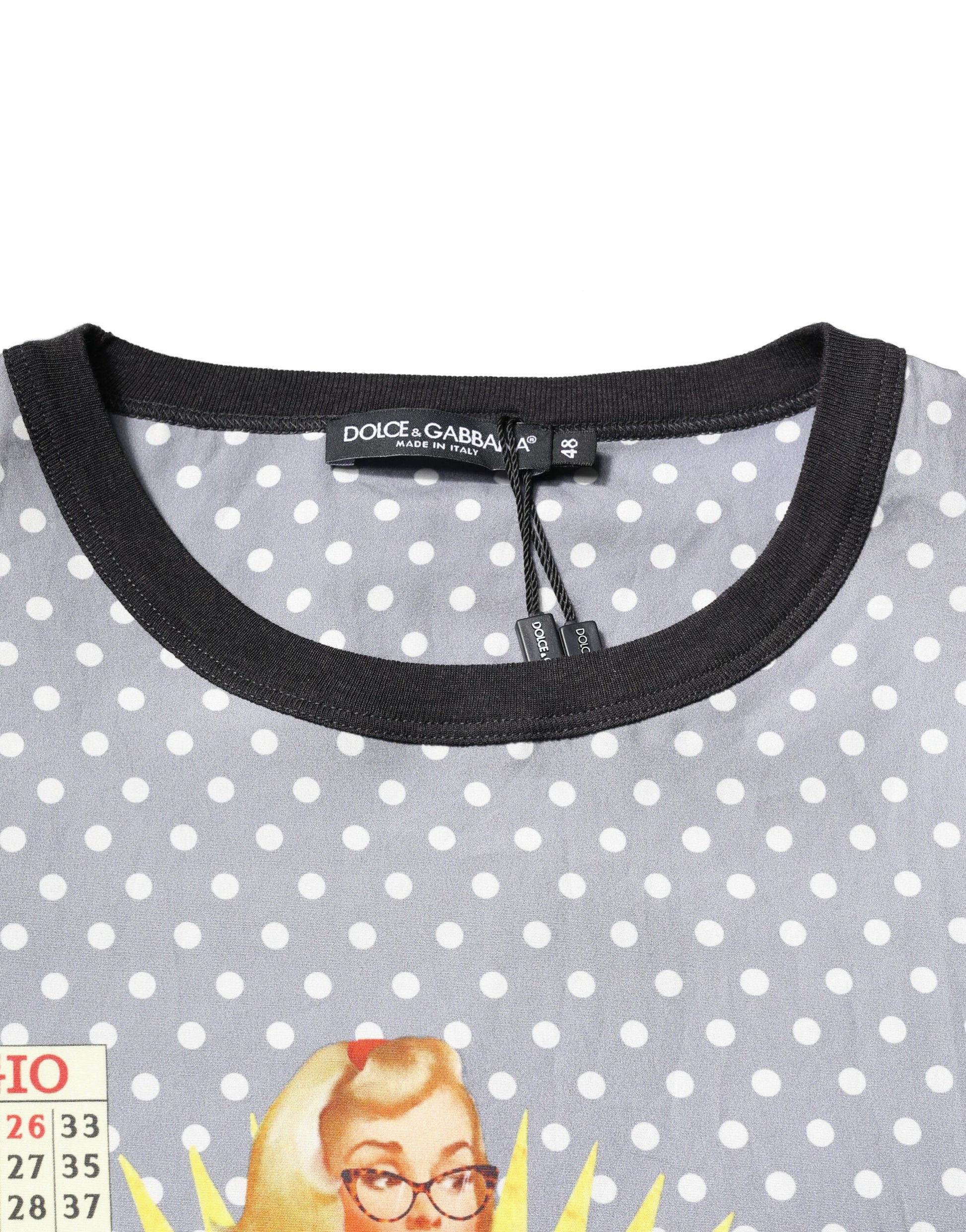 Black polka dot t-shirt with a cartoon face on front