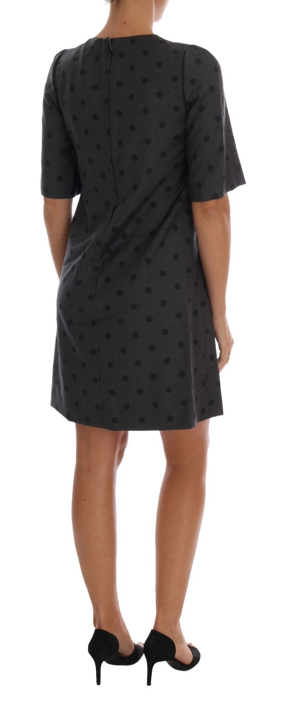 A gray polka dotted sheath wool dress with a V-neckline and short sleeves