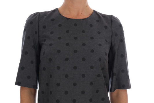 A gray polka dotted sheath wool dress with a V-neckline and short sleeves