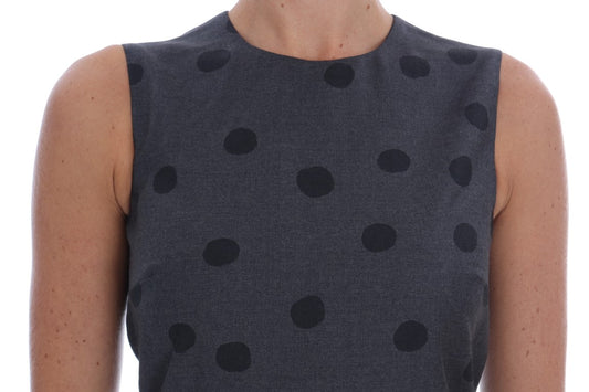 A gray polka dotted sheath wool dress with short sleeves and a round neckline