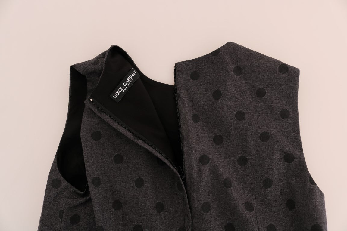 A gray polka dotted sheath wool dress with a zippered front and long sleeves